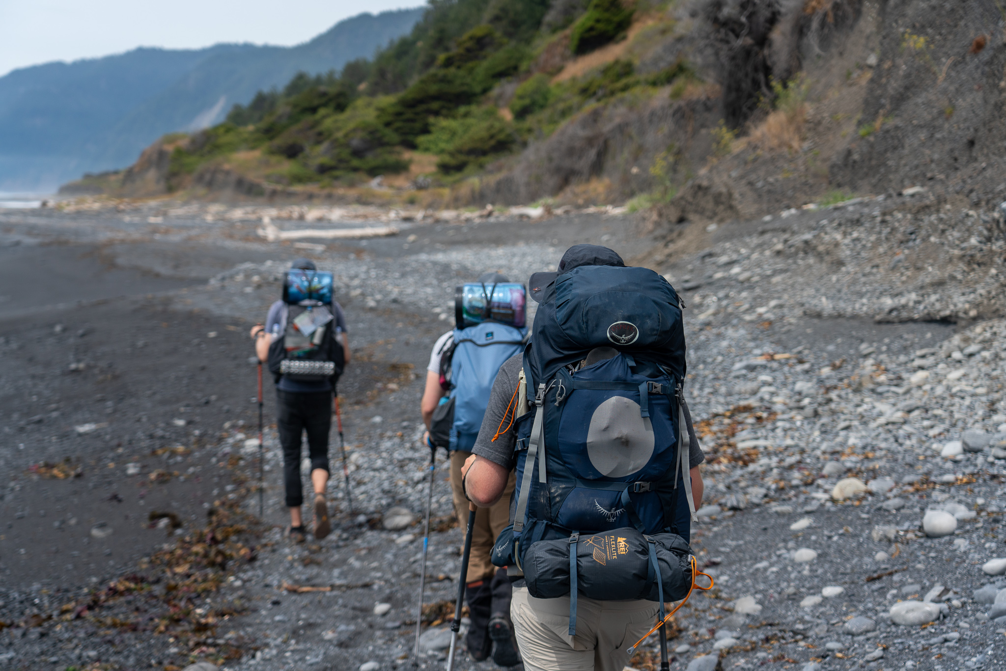 Chad, Adam, and Keith hiking on the beach